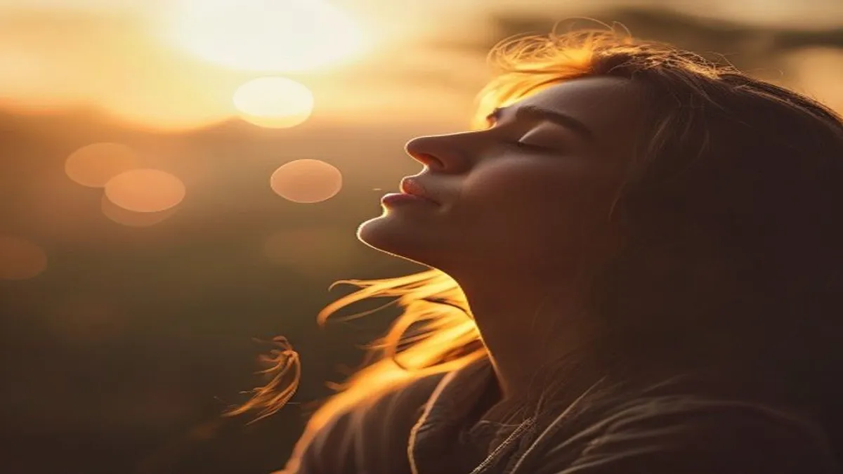 Person breathing deeply at sunrise overlook.