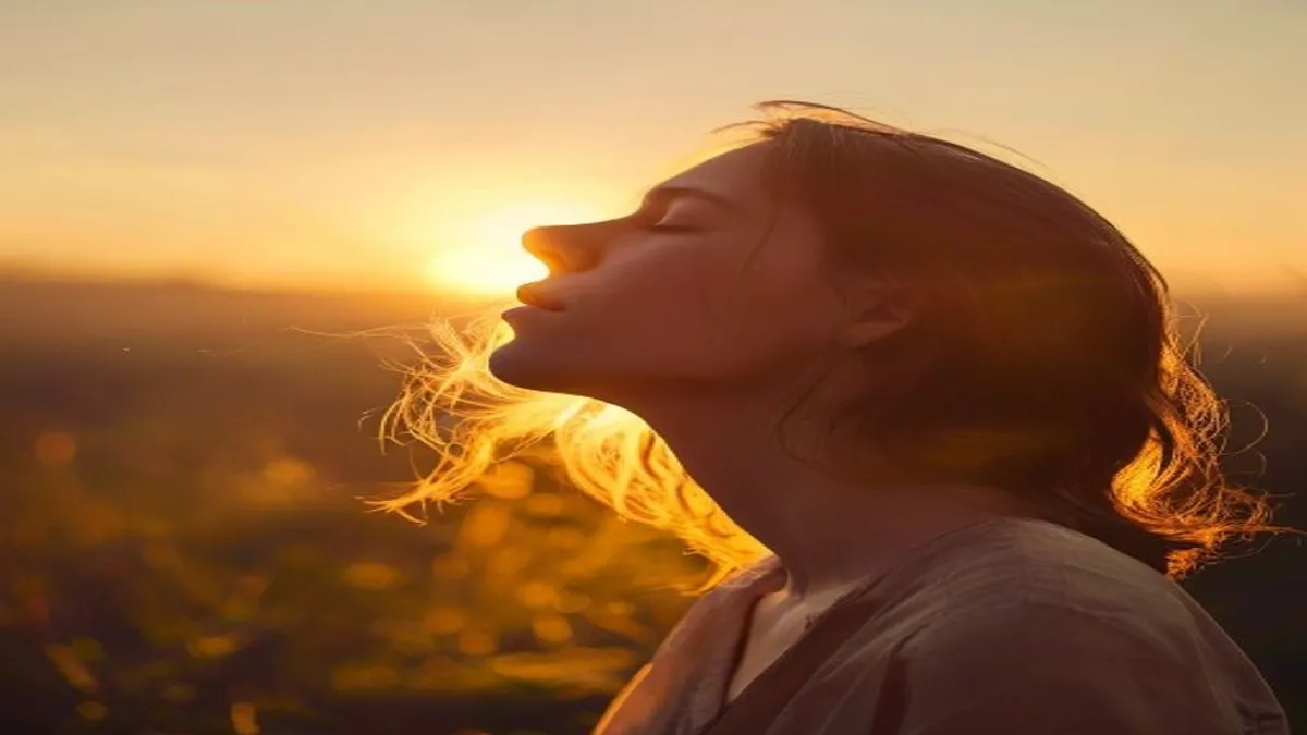 Person breathing deeply at sunrise overlook.