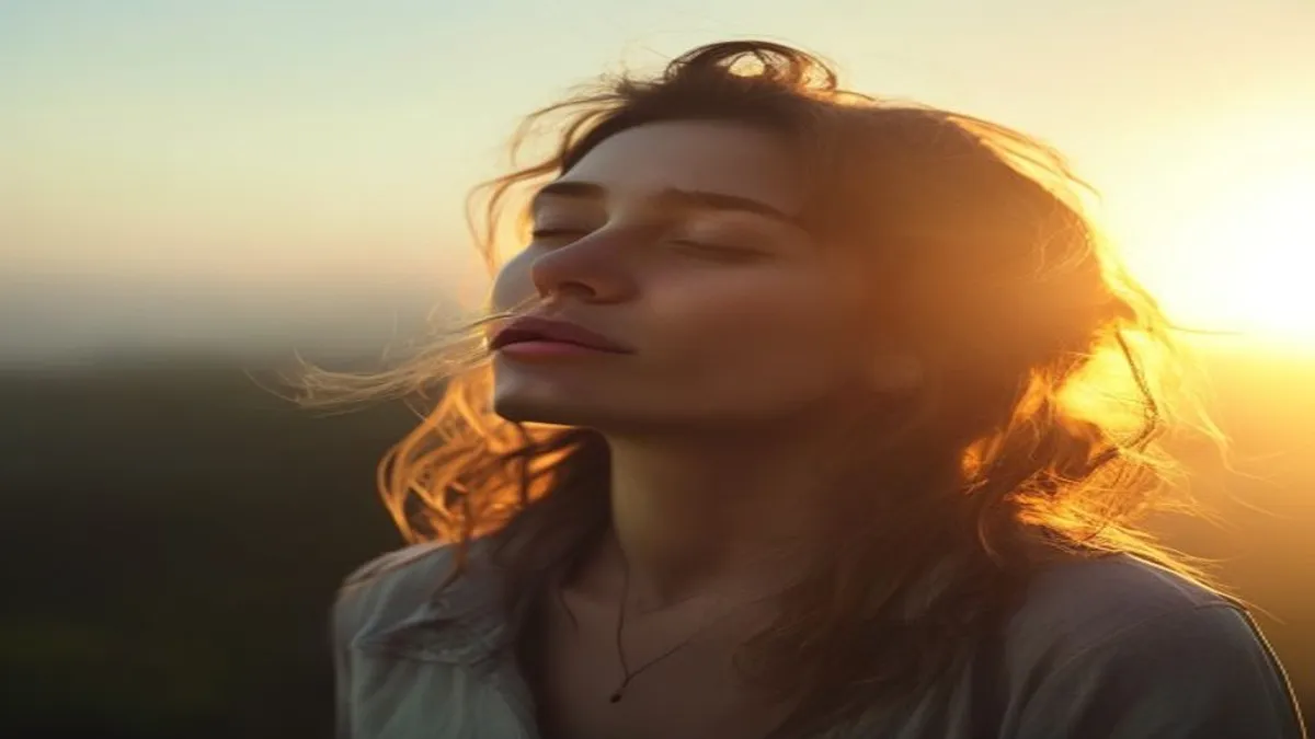 Person breathing deeply at sunrise overlook.