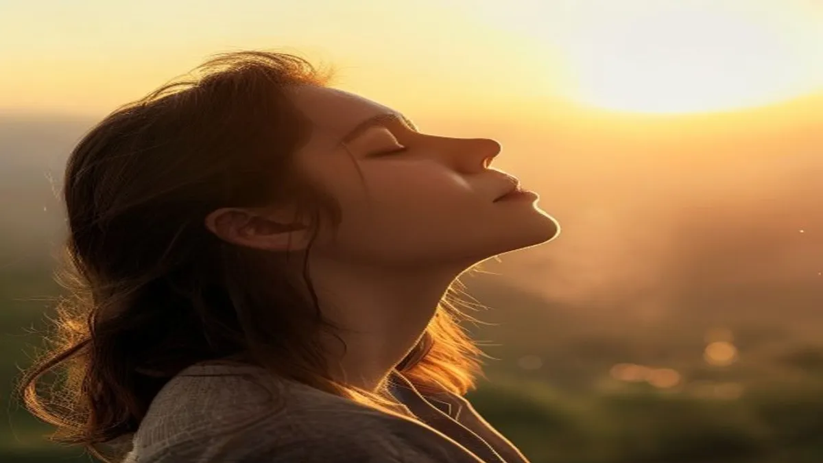 Person breathing deeply at sunrise overlook.