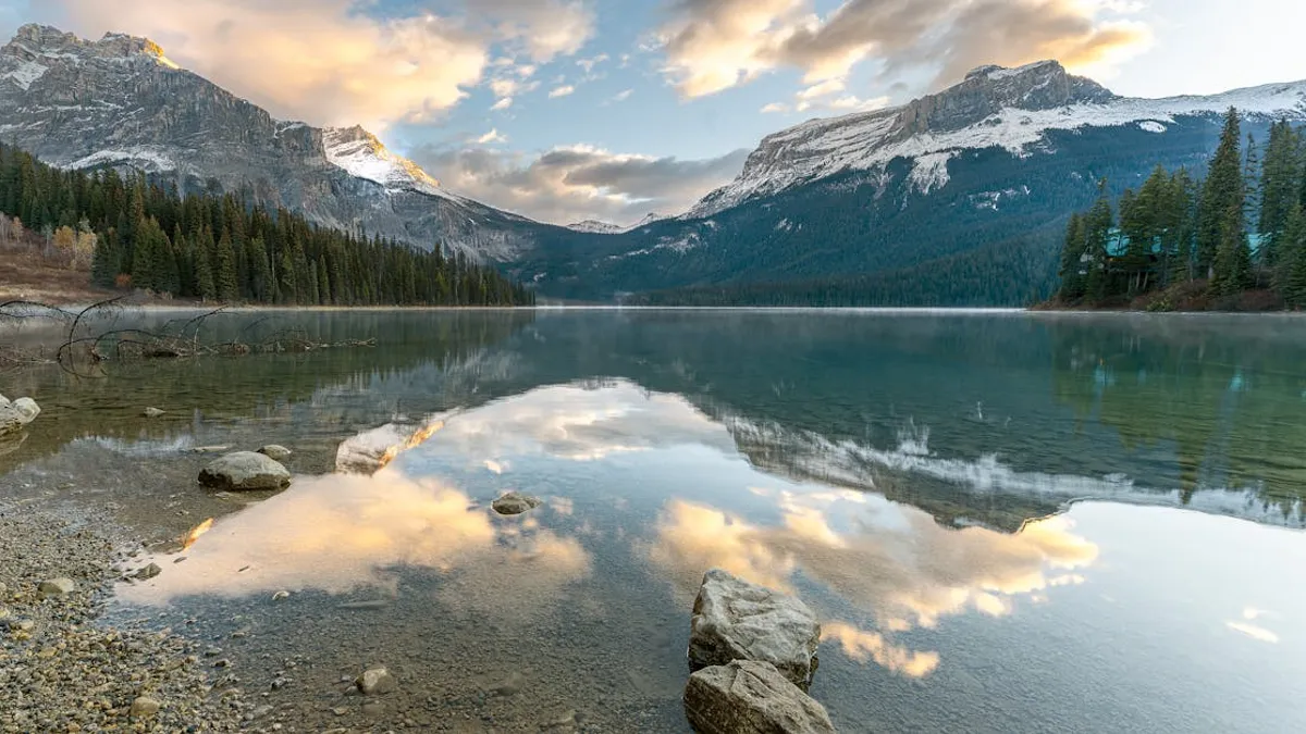 Stunning view of a lake reflecting mountains and clouds in Banff, Alberta, Canada.
