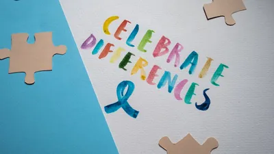 Colorful typography and puzzle pieces celebrate diversity and uniqueness.