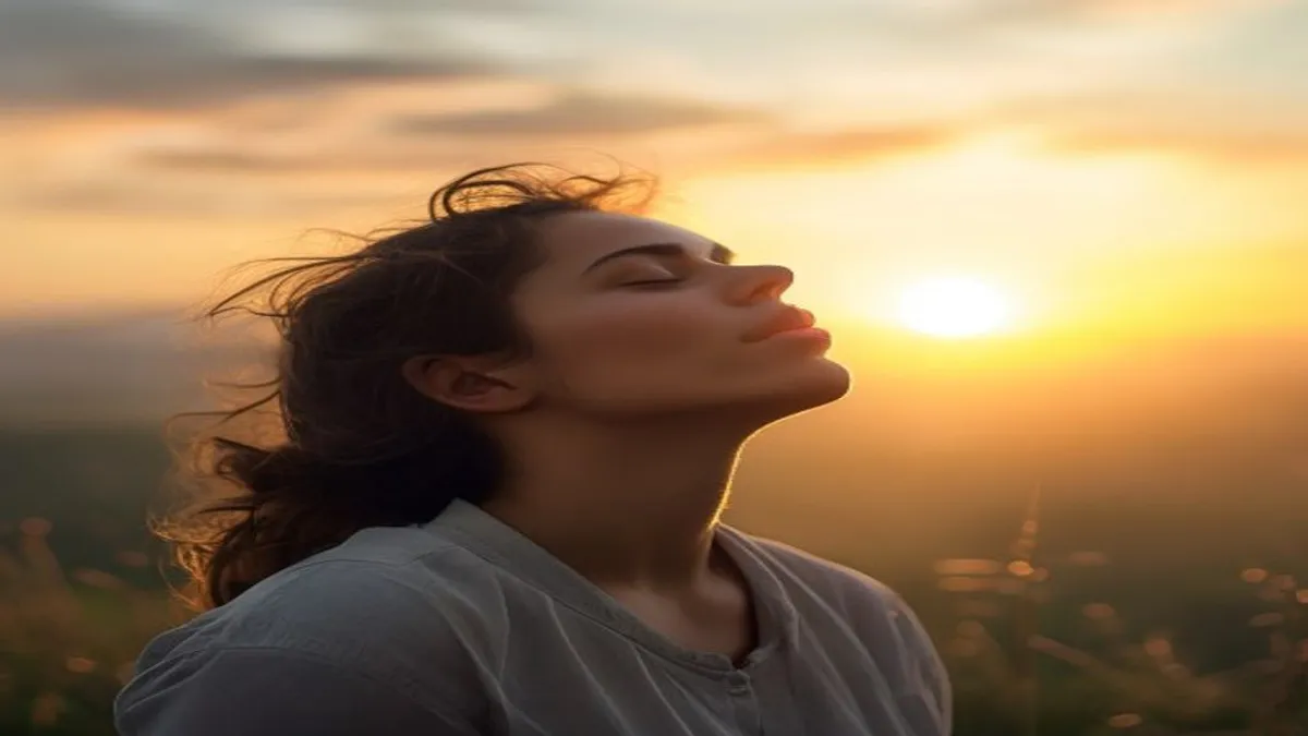 Person breathing deeply at sunrise overlook.