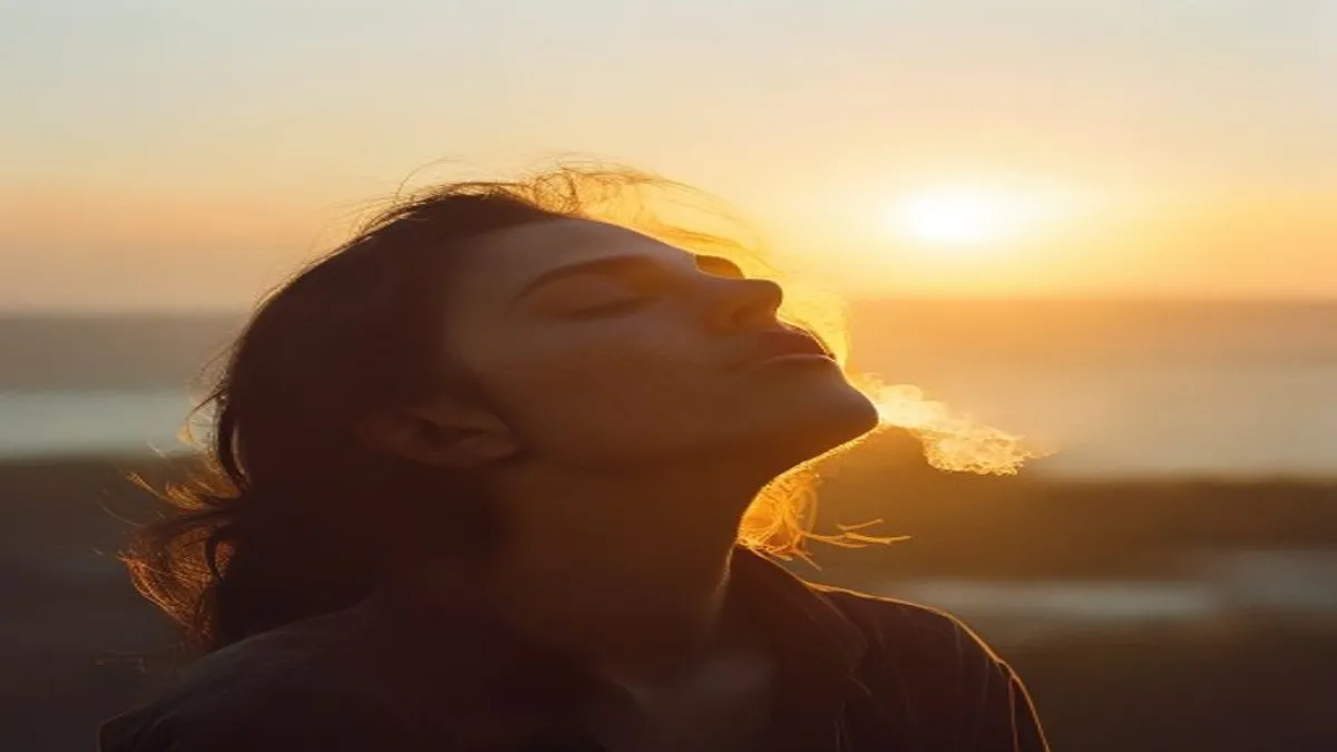 Person breathing deeply at sunrise overlook.