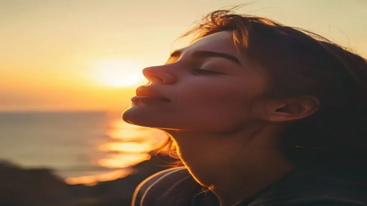 Person breathing deeply at sunrise overlook.